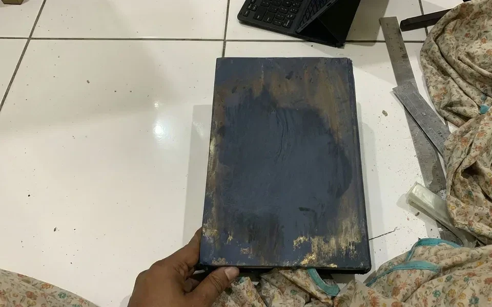 Heavy dusting restoration on damaged book cover
